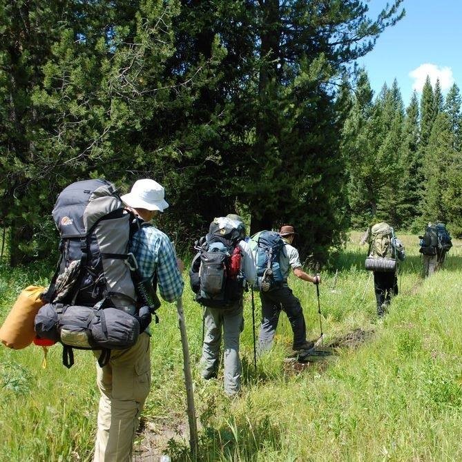 A group walking with backpacks.