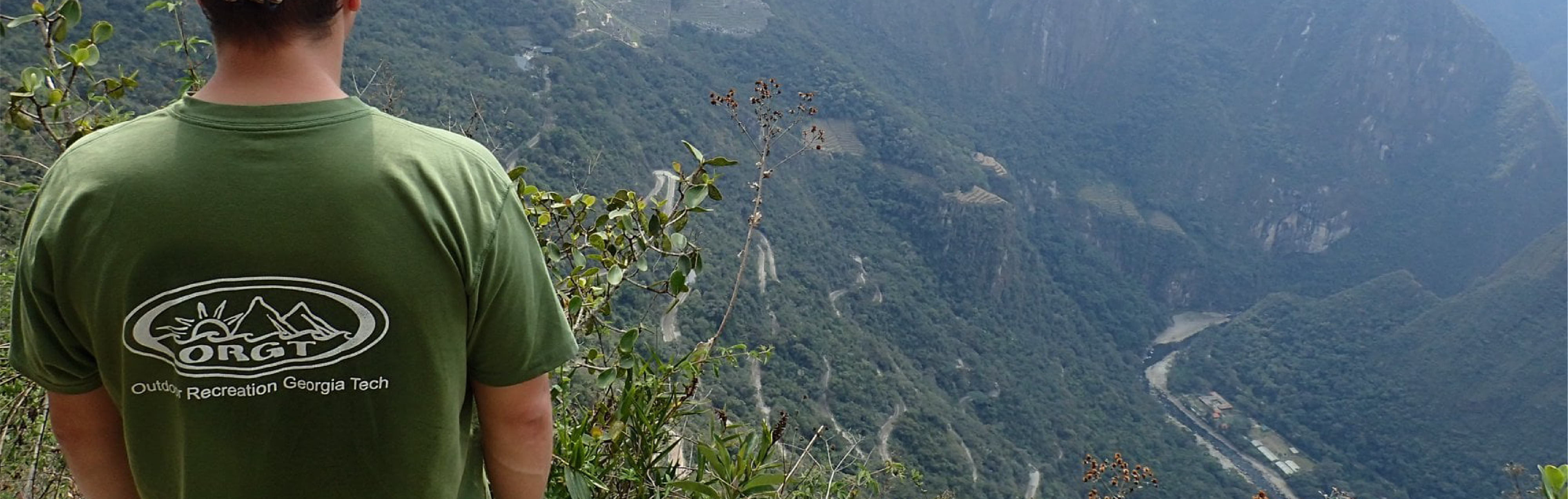 A student wearing an ORGT shirt, looking at the mountain view