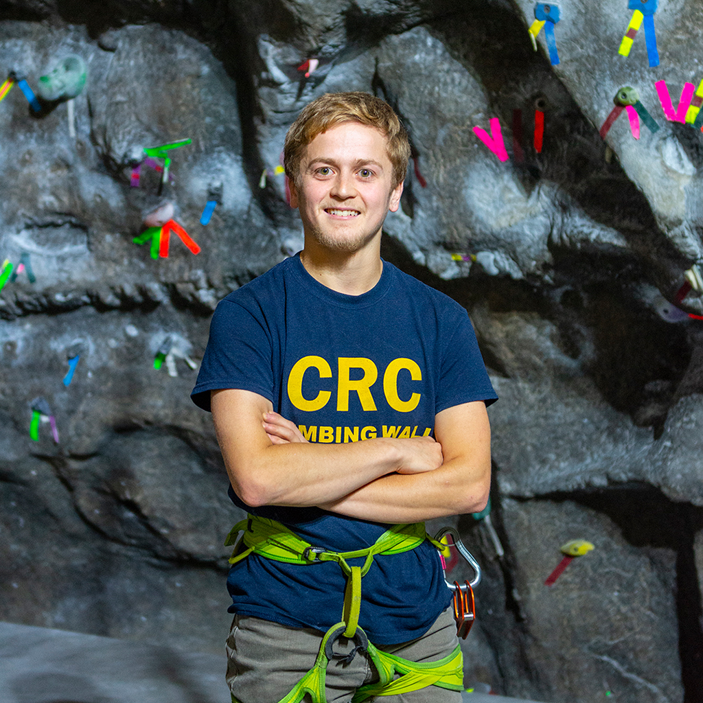 A male climbing wall attendant.